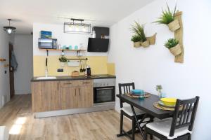 a kitchen with a table and a dining room at La CaSita in Vara de Rey