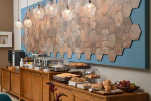 a buffet line with bread and pastries and lights at Maison Hotel in Halkidona