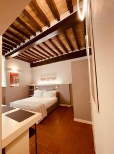 a bedroom with a bed and a kitchen in a room at Palazzo Borgocolonne Apartments in Parma