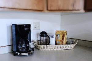 a coffee maker and a basket on a kitchen counter at Charming, Spacious, Contemporary Mountain Retreat in Whitehall +33 photos