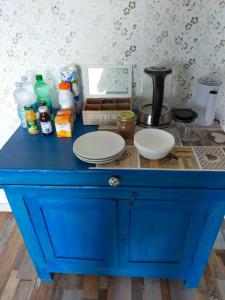 a blue dresser with plates on top of it at BnB La Casina dei Nonni in Campofilone