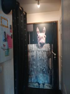 a painting of a donkey sticking its head out of a door at Avoriaz cocooning in Avoriaz