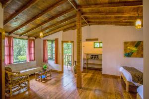 a large living room with a bed and a couch at San Isidro Lodge in Cosanga