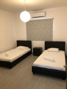 阿依納帕的住宿－Katalimata Court，一间卧室配有两张床和灯具