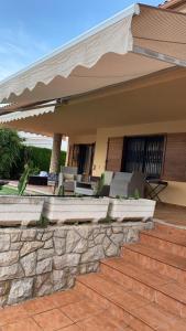 a home with a patio with a stone wall at Iberflat Villa Tramontana in Benicàssim