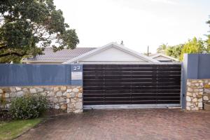 a gate in front of a house at The Paper Fig House in Plettenberg Bay
