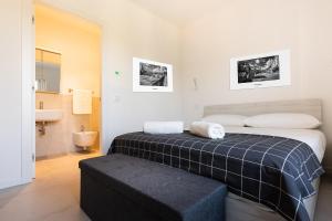 a bedroom with a bed and a bathroom with a sink at Verona Suites in Verona