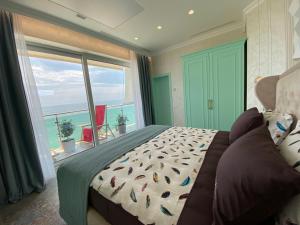 sypialnia z łóżkiem i widokiem na ocean w obiekcie UnderSun Spa Hotel w mieście Hrybiwka
