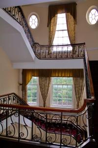 a spiral staircase in a house with two windows at The Station Aparthotel in Dudley