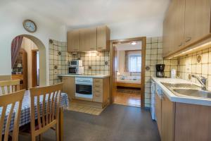 a kitchen with a sink and a counter top at Ferienwohnung Helga Bergkirchner in Schwallenbach