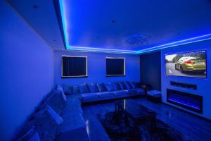 a living room with a couch and a tv at Waterfront luxury apartment in Kinghorn