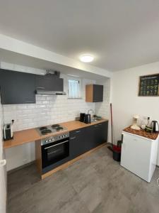 a kitchen with a stove and a counter top at Ferienwohnung Einstein in Feldkirch
