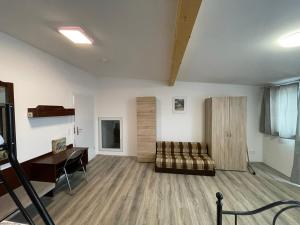 a living room with a couch and a desk at Ferienwohnung Einstein in Feldkirch