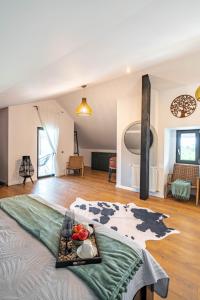 a large room with a bed with a tray of fruit on it at Craita Merelor The PLACE in Aninoşani +119 photos