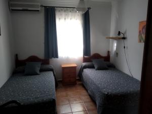 A bed or beds in a room at Alojamientos Andalucia