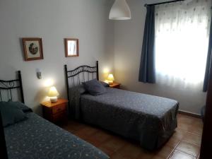 A bed or beds in a room at Alojamientos Andalucia