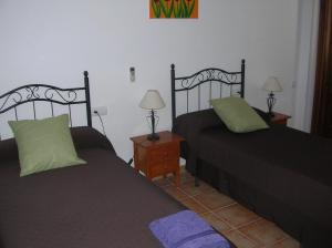 A bed or beds in a room at Alojamientos Andalucia