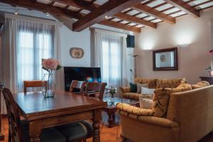 a living room with a table and chairs at Menurka-Santa Clara in Ciutadella