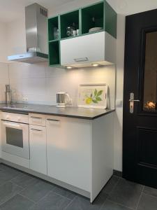 a kitchen with white cabinets and a counter top at Ferienwohnung Klosterblick in Ühlingen-Birkendorf