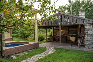 a wooden shed with a table in a yard at Emma Villa in Pärnu