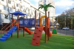 a playground with a slide and a play structure at Premium Vila Velha Hotel in Ponta Grossa