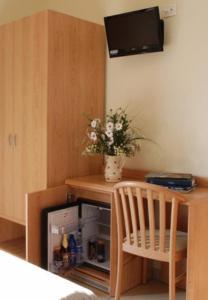 a small kitchen with a small refrigerator and a chair at Locanda Canareggio in San Biagio di Callalta