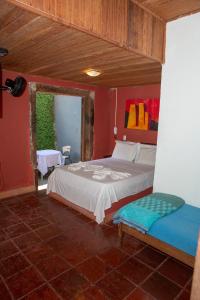 a bedroom with a bed and a chair in it at Planeta Macacos in Macacos
