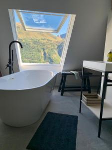 a bath tub in a room with a large window at Villa Le Ponteil in Les Deux Alpes