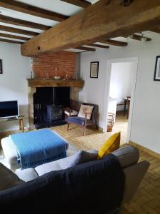 a living room with a couch and a fireplace at Gite No 16 in Châteauponsac