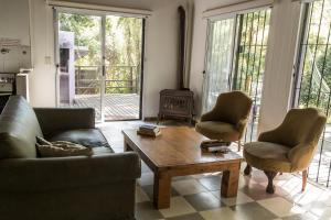 a living room with a couch and two chairs and a coffee table at La Mamunia in Las Gaviotas