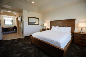 a bedroom with a large bed and a bathroom at Jackson Rancheria Casino Resort in Jackson