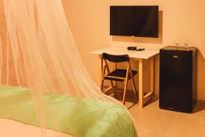TV a/nebo společenská místnost v ubytování Pousada Mahalo Fulô