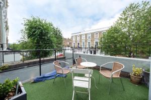 a lawn chair sitting in front of a patio at Notting Hill Hotel by CAPITAL in London