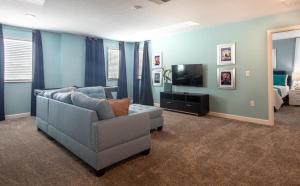 uma sala de estar com um sofá e uma televisão em 820DSD - The Retreat at ChampionsGate em Davenport