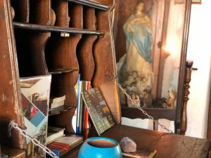 a shelf with books and a blue vase on a table at Casa de Los Berrios in León