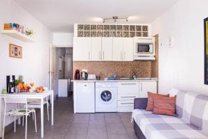 a kitchen with a couch and a table in a room at Apartamento MareVerde Las Americas in Adeje