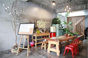 a room with a desk and a table with a painting at Anping Light in Anping