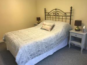 a bedroom with a bed with a pillow on it at Charming 1-Bedroom Apartment near South Downs in Hailsham