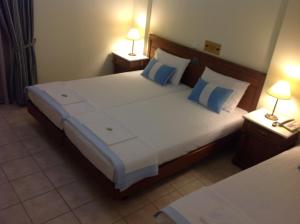 A bed or beds in a room at Florena Hotel