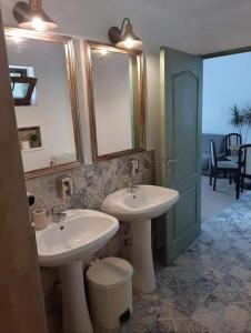 a bathroom with two sinks and a mirror at Annador in Jupiter +49 photos
