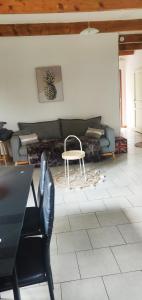 a living room with a couch and a table at Chez Fanny - Les Tuileries - Gîte 1-4 pers. avec jardin privatif - proche Cahors in Le Montat