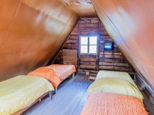 a room with three beds in a wooden cabin at Hotel, boungalow y cabañas Xanfari in Colorado