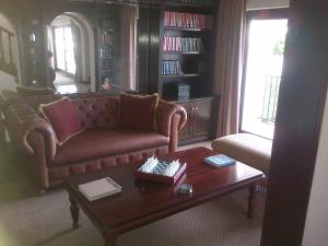 a living room with a couch and a coffee table at Pelagus Guest House in Hermanus