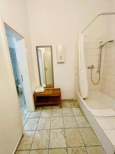 a bathroom with a tub and a shower and a sink at Altstadthotel Hayk am Rhein in Cologne