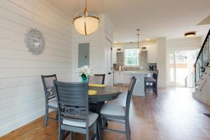 a dining room and kitchen with a table and chairs at The Cottonwood in Clayton