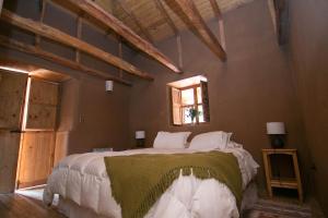 a bedroom with a large bed in a room with a window at Hotel Casona Distante in Alcoguaz