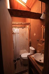 a bathroom with a toilet and a sink at Hotel Casona Distante in Alcoguaz