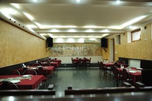 a dining room with red tables and chairs at Villa 29 in Yerevan