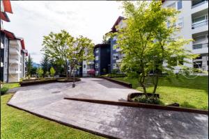 a park in a city with a tree and buildings at Exceptional Deluxe Apartment Pucon near Lake and Volcano in Pucón