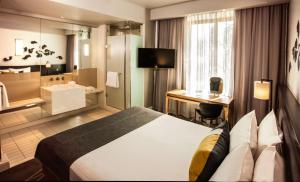 a hotel room with a bed and a desk at Piazza Hotel Montecasino in Johannesburg